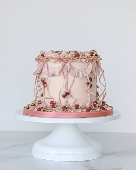 Vintage pink buttercream Mother’s Day cake with ruffles and florals