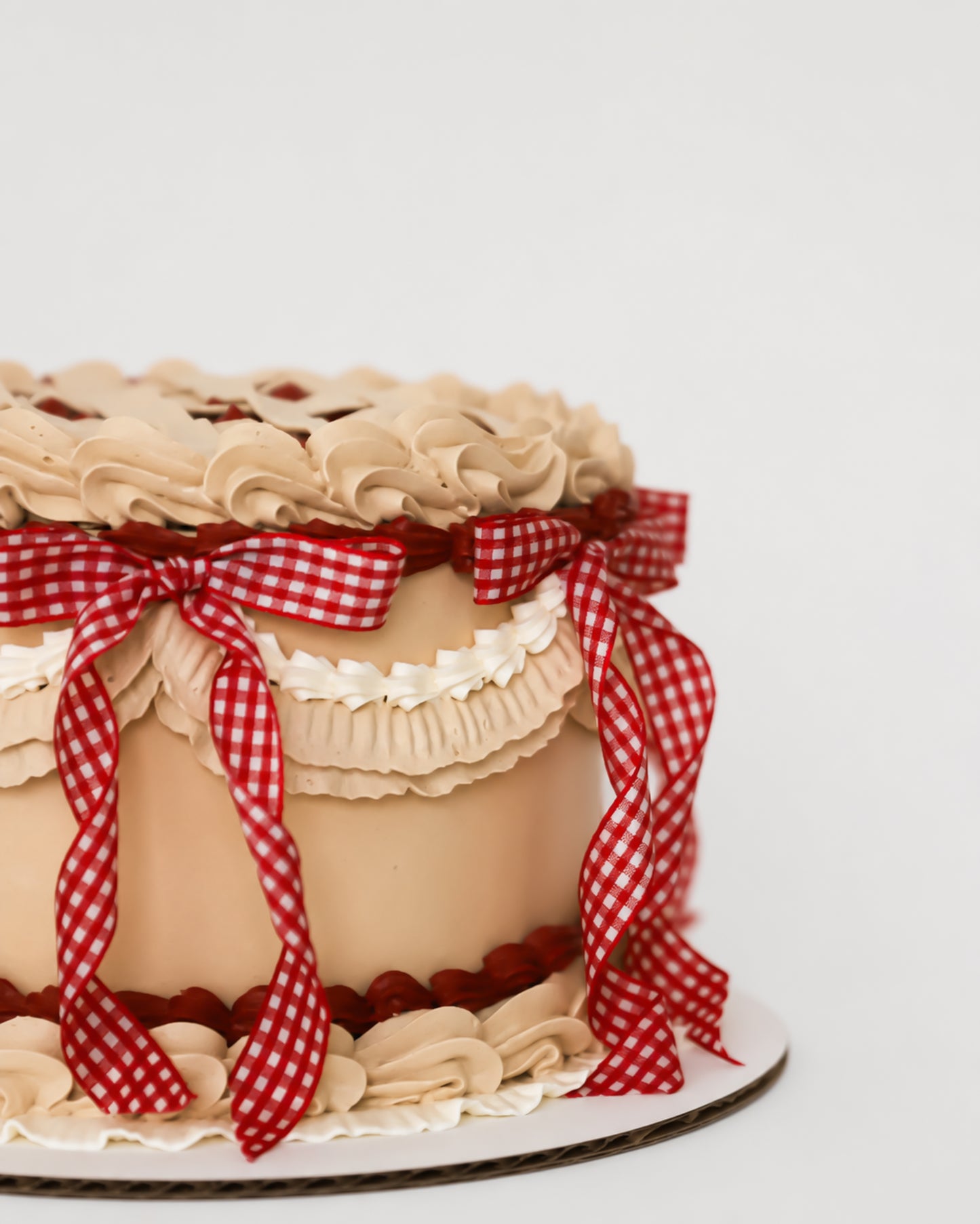 Sweetie Pie cherry vintage lattice cake showing cream ruffle band, red gingham ribbon, and scalloped base border detail