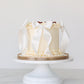 Vanilla buttercream Mother’s Day cake with white satin bows