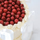Close-up of fresh raspberries and buttercream swirl border