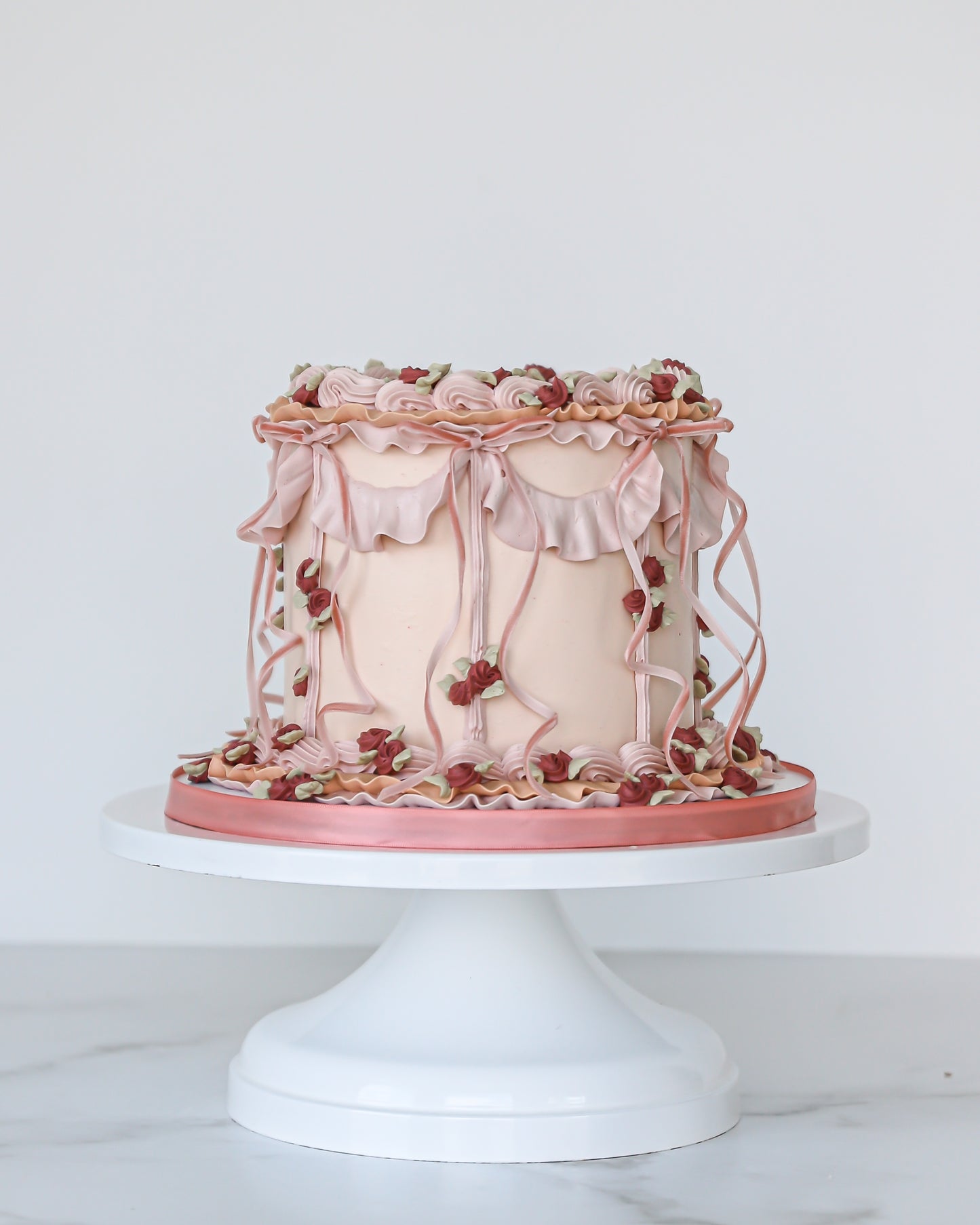 Vintage pink buttercream Mother’s Day cake with ruffles and florals
