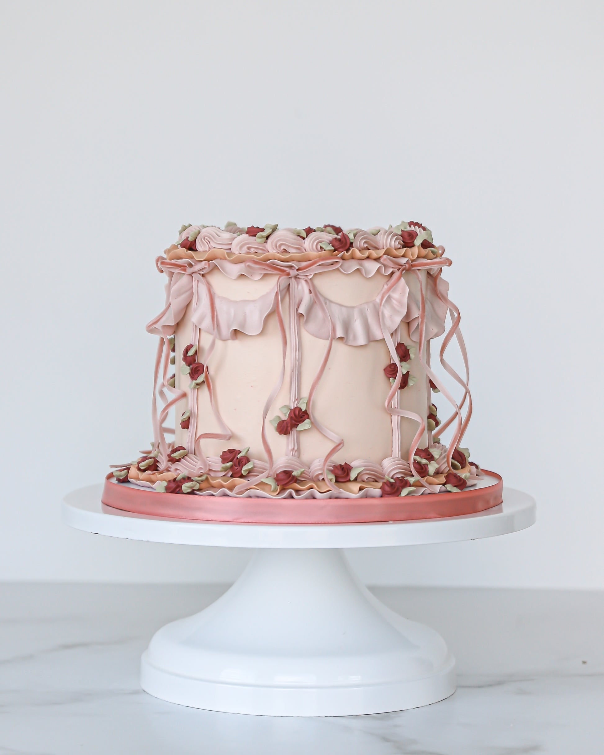 Vintage pink buttercream Mother’s Day cake with ruffles and florals
