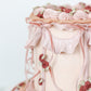 Close-up of ruffled buttercream and piped floral detailing