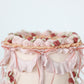 Top edge detail of vintage cake with pink swags and florals