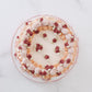 Top view of vintage buttercream cake with piped floral border
