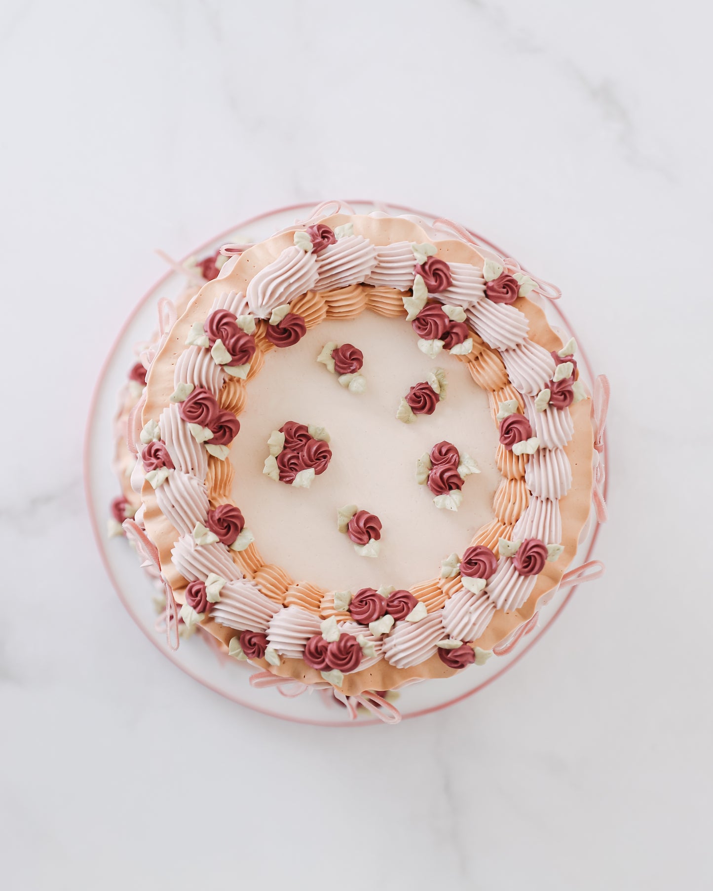 Top view of vintage buttercream cake with piped floral border