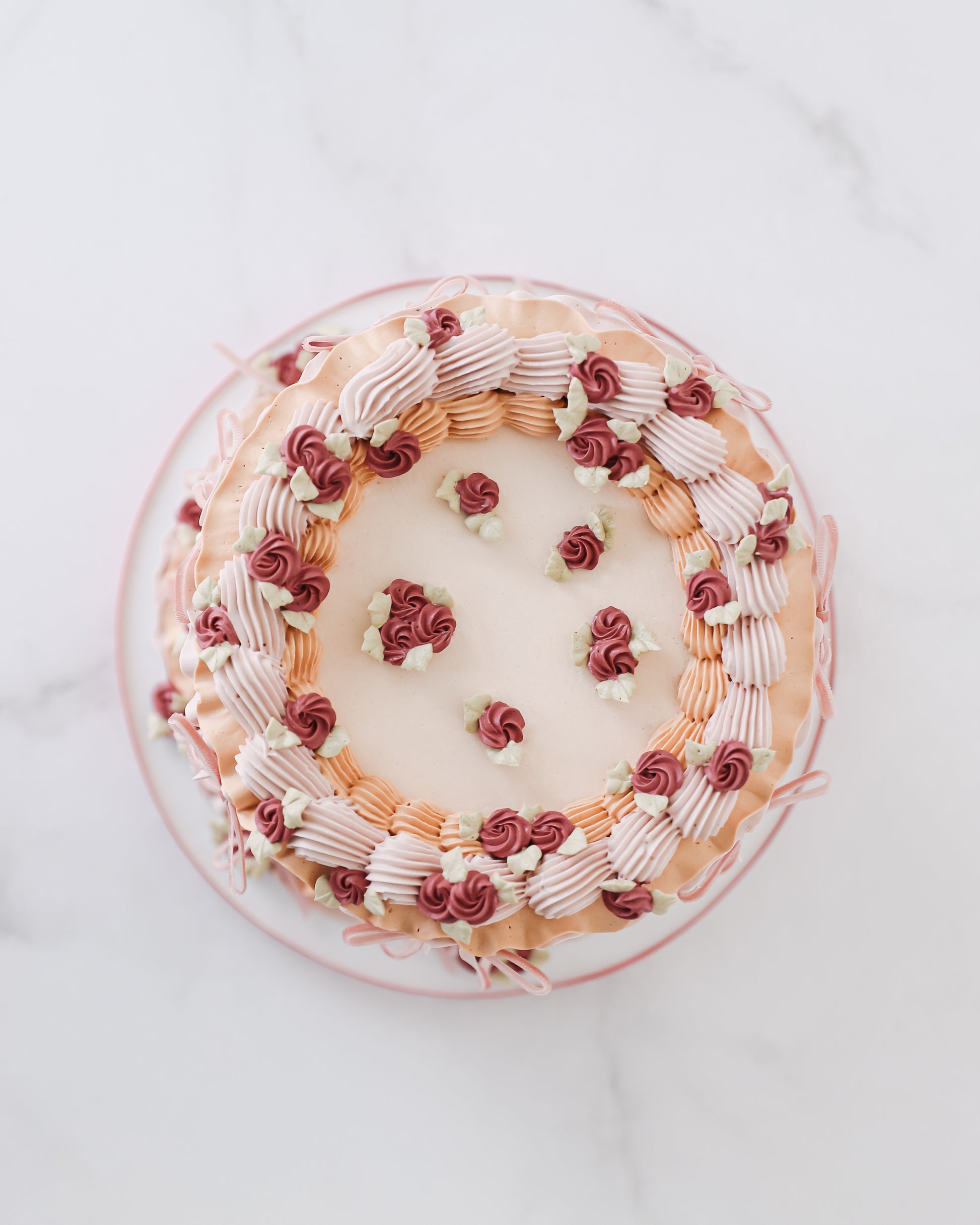 Top view of vintage buttercream cake with piped floral border