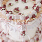 Close-up of piped floral border on vintage style cake
