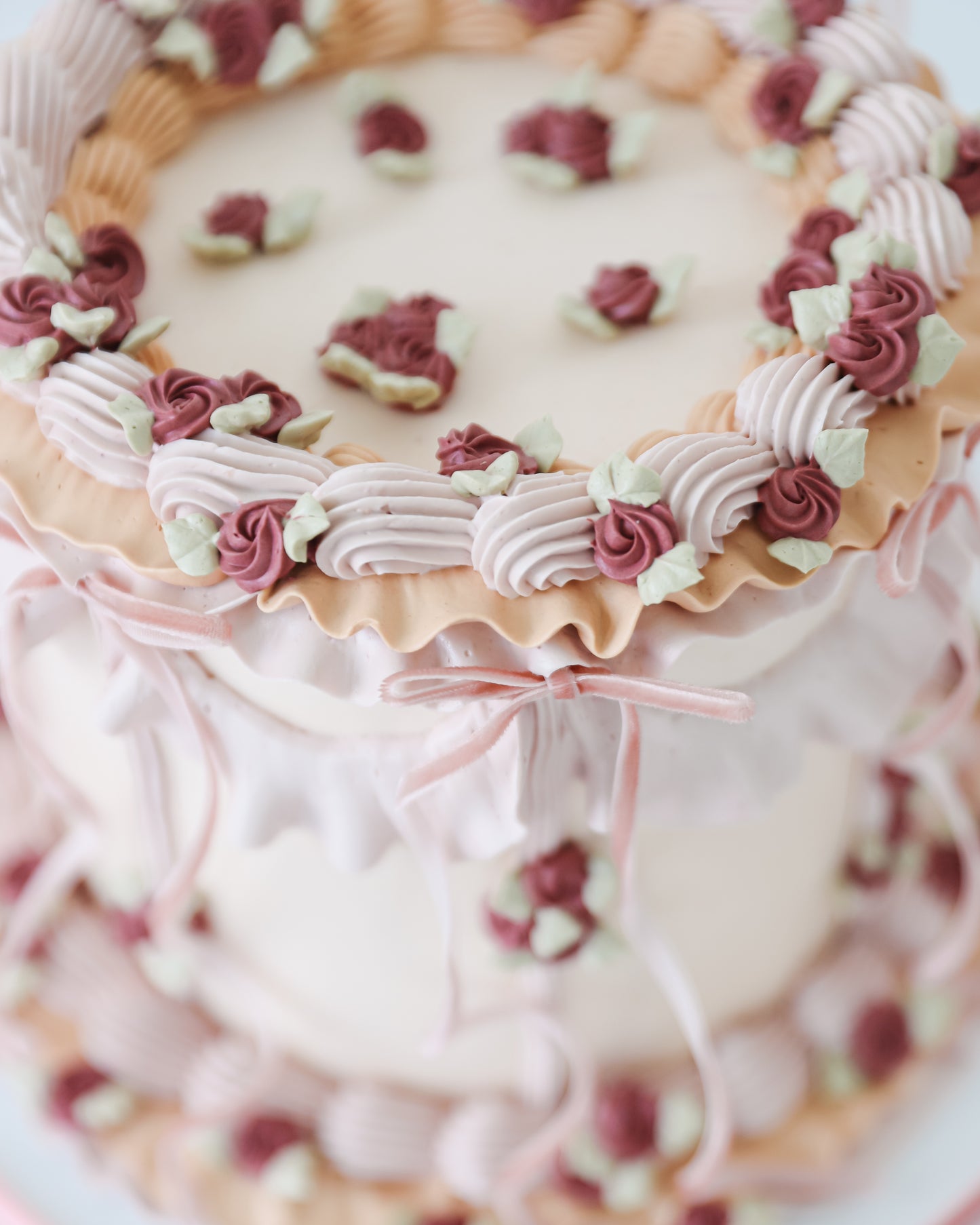 Close-up of piped floral border on vintage style cake