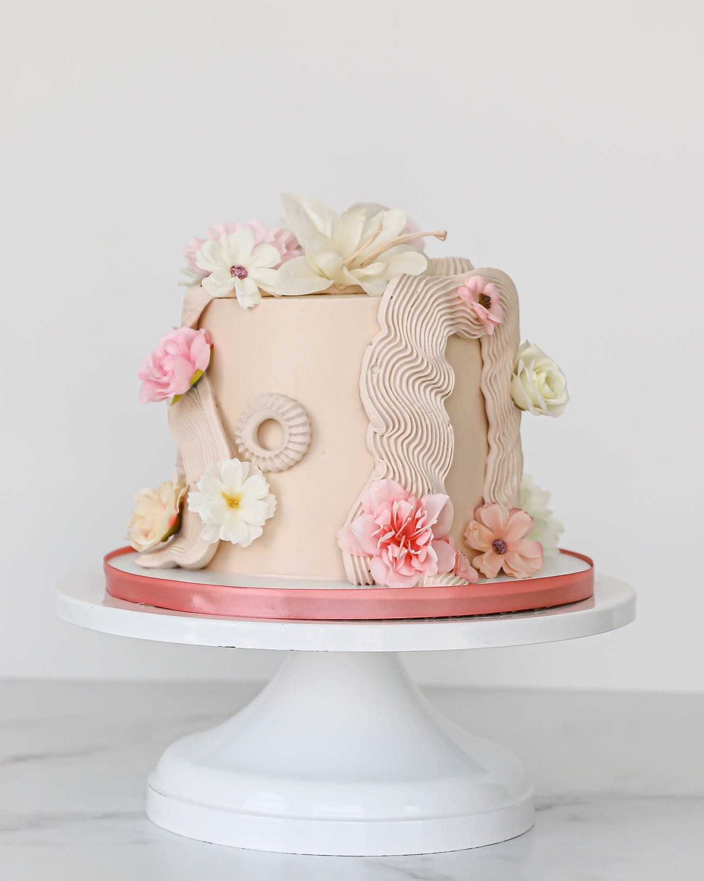 Buttercream floral Mother’s Day cake with blush and ivory sugar flowers