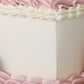 Close-up of pink buttercream piping and smooth cake finish