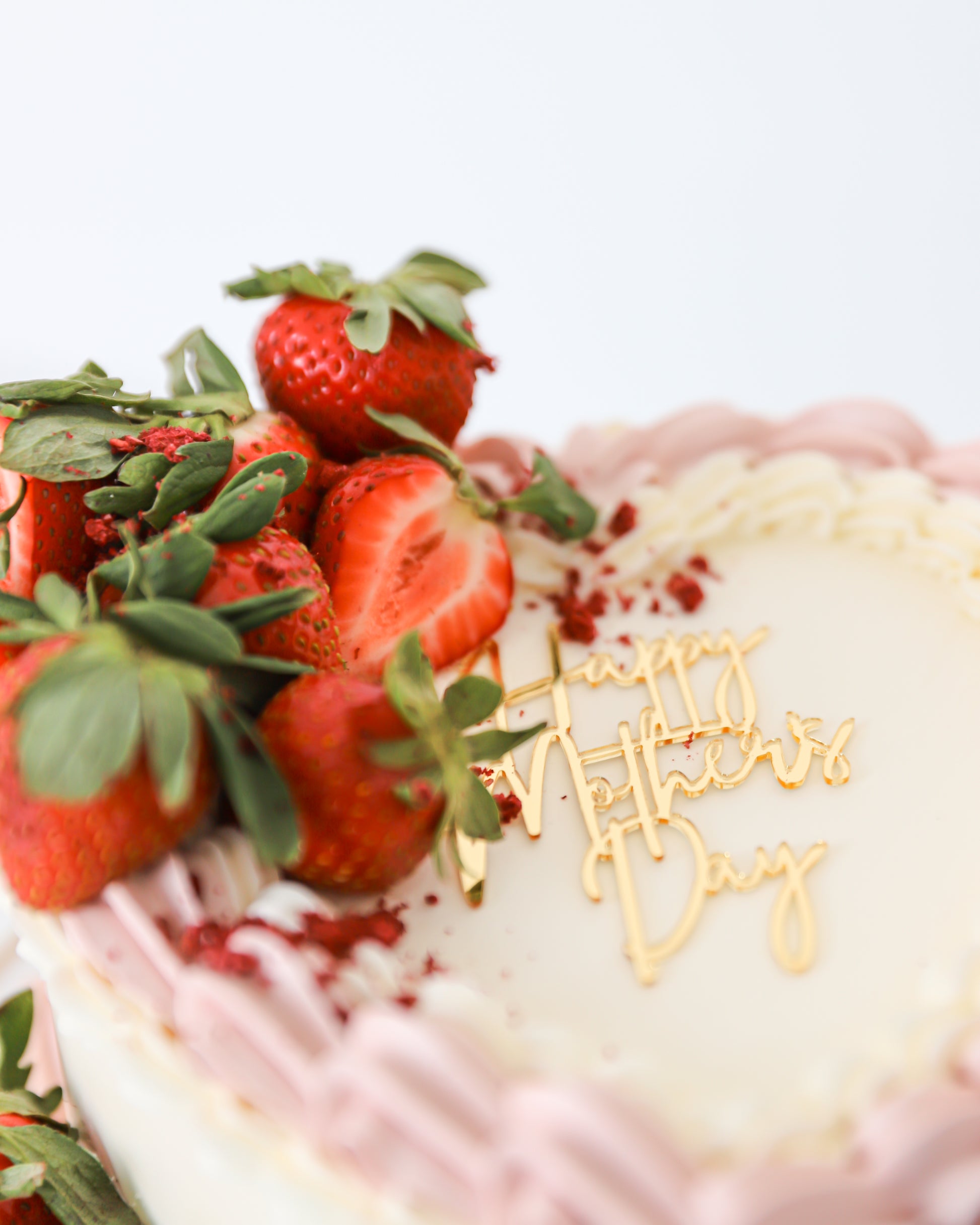 Fresh strawberry topped cake with Mother’s Day topper