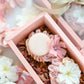 Blush pink cakelet gift box with macaron and floral buttercream design