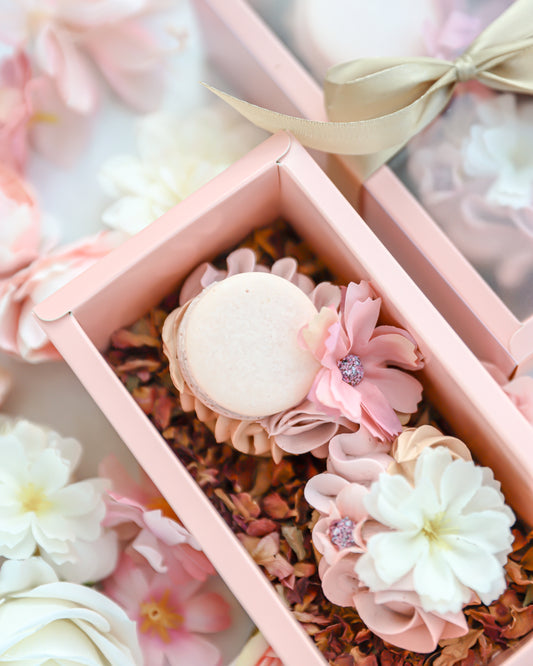 Blush pink cakelet gift box with macaron and floral buttercream design