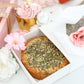 Close-up of seeded mini cake in white bakery gift box