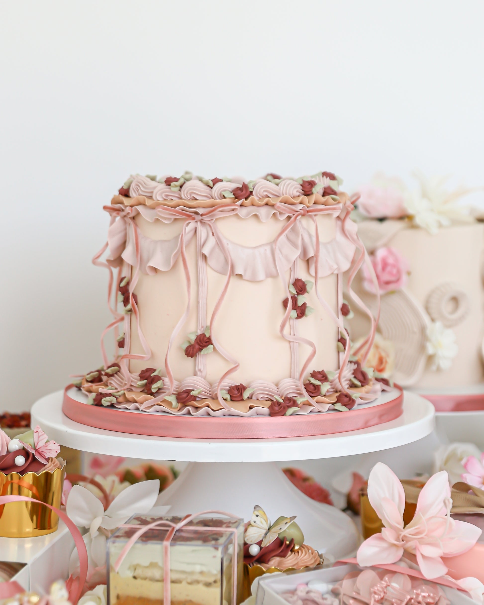 Vintage Mother’s Day cake display with pastel desserts and florals