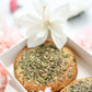 Seeded tea cake in luxury gift box with soft pink floral styling