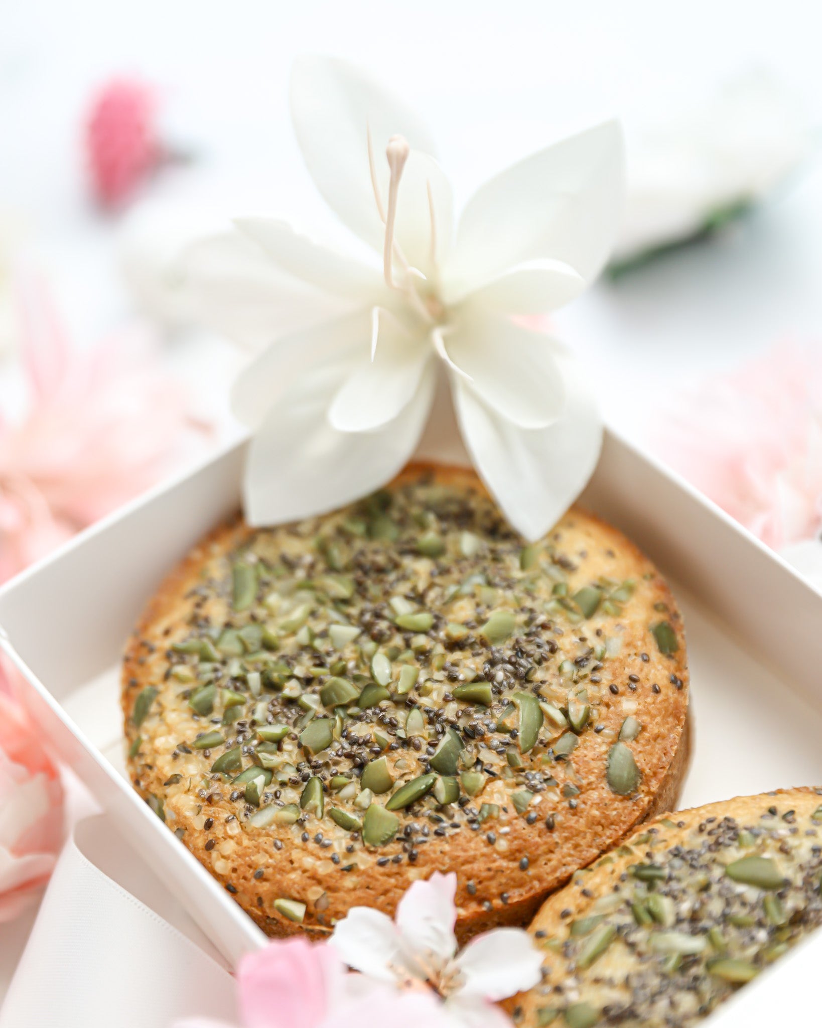 Seeded tea cake in luxury gift box with soft pink floral styling